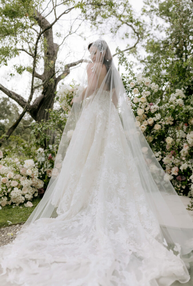 Melanie Lee in Misha gown with matching veil and topper